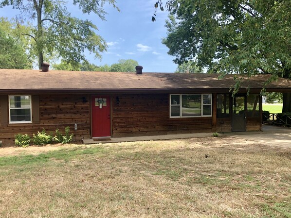 Two bedroom/one bath house, screen porch and carport on a corner lot