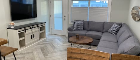 Living room with sectional couch (pullout bed) and large flat screen tv 