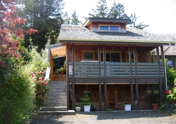 parking /storage, front door top of stairs. Deck / table four chairs and swing.