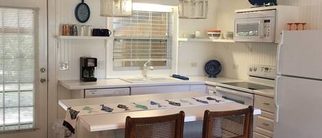 Cozy and cute kitchen opens to screened porch