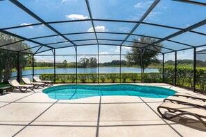 Large pool deck with loungers and amazing lake view