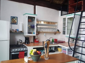 Kitchen view shows blender, coffee maker and tea kettle