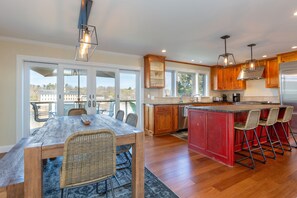 A fully stocked kitchen with seating for 10 at the dining table and island. 