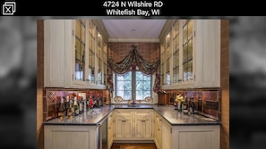 Fully stocked bar with refrigerator and ice maker