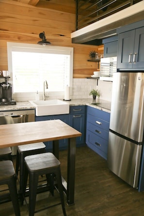 With a farmhouse sink, full-size fridge, stove top, convection microwave oven and more, you’ll love preparing meals in the kitchen!
