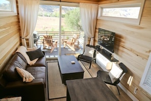 How big is 400 square feet? Bigger than you imagine! The living room in this tiny home is cozy and inviting, with plenty of seating for everyone to relax and socialize. At night, you can open the sofa up to have a queen-size sleeper.