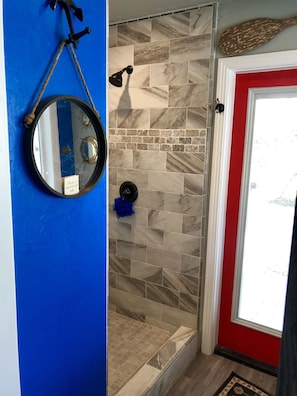 Very spacious shower. Door to private area outside.