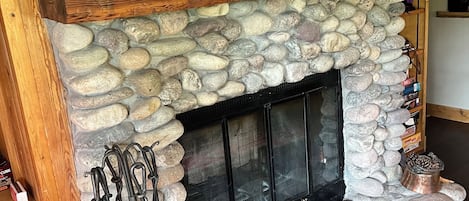 Wood-burning natural stone fireplace