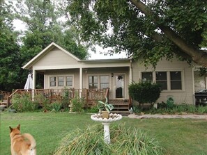 Spacious green space with wrap around porch.