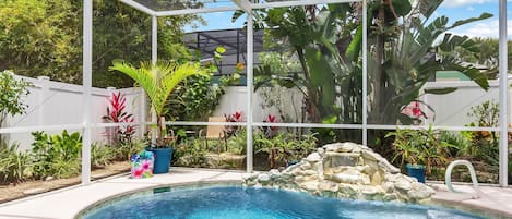 Private screen enclosed pool with waterfall features