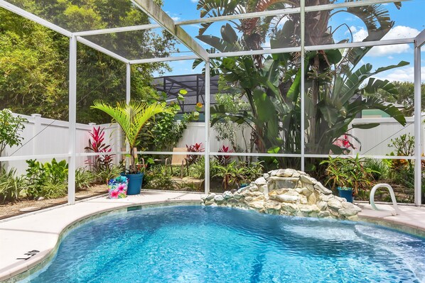 Private screen enclosed pool with waterfall features