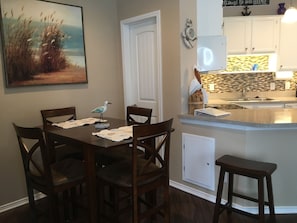 Open kitchen flowing into dining area and living area
