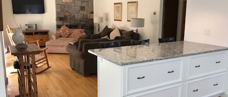 View of living room from kitchen.  Open space for gathering with family/friends