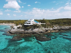 The Point House is surrounded by turquoise water & coral reefs