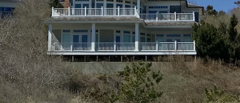 View of the house from the beach. Access to the beach is via path and boardwalk.