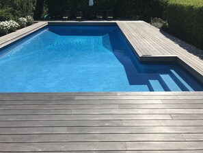 Pool with new mahogany decking. Plenty of seating and umbrellas.