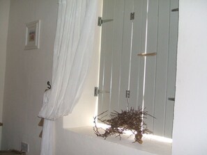 Window detail with shutters and lace pull.