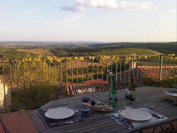 Dinner on the terrace overlooking the vineyards that stretch to the sea..