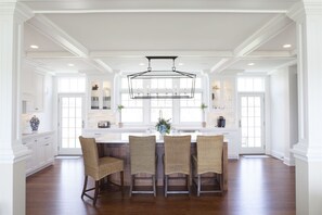 The kitchen island with four stools.