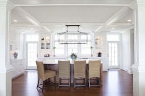 The kitchen island with four stools.