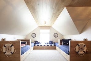 The bunk room with four twin beds and one full bed.