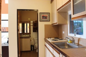 kitchen equipped w/small refrigerator, stovetop, microwave, coffee maker, plates