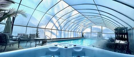 The heated pool and hot tub are enclosed for winter swimming.  