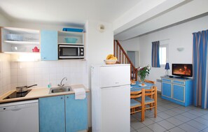 Prepare meals in the kitchenette and enjoy them at the dining table.