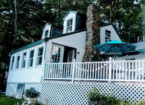 water side of camp with deck. doors open to dining room