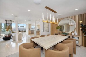 Dine beneath warm lighting in a room wrapped in natural wood.
