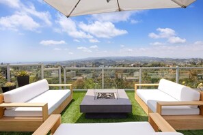 The outdoor lounge space features a gas fire pit with seating for all your guests.
