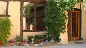 Gite front door, kitchen window & kitchen garden
 seen from courtyard