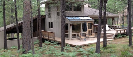 Golf course view of home and deck