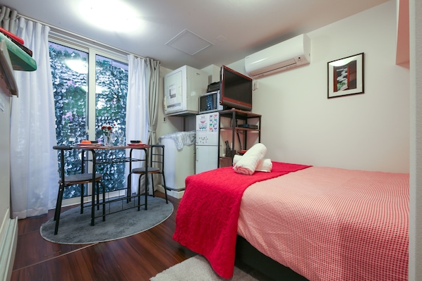Relax in comfort in this bright studio with full amenities and a charming garden view