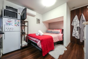 Sink into a plush double bed with fresh linen, perfect for couples or solo travellers