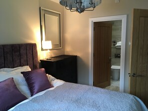 Master bedroom on the first floor with ensuite and tv.