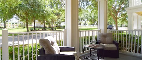 Beautiful balcony with comfortable seating and views to the community pool