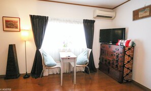 Enjoy meals or work from this bright window nook, perfectly paired with cultural furnishings.