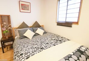 Relax in plush bedding surrounded by warm lighting and natural textures