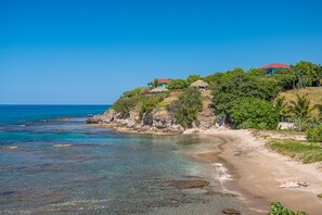 Set on a cliff with stairs leading to a secluded beach