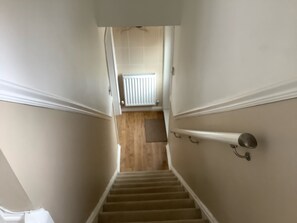 Stairs to downstairs bathroom, living room and kitchen.