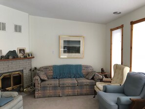 Large living room with wood-burning fireplace