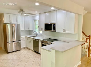 Updated kitchen with new cabinets, appliances and sleek quartz countertops.  