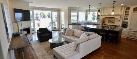 Back living room + kitchen with french doors to the backyard