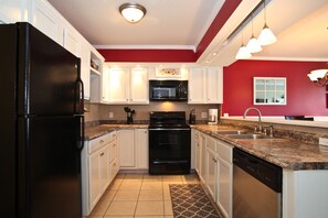 Fully-equipped kitchen opens up to dining/living rooms