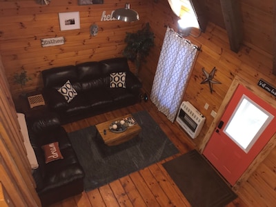 Evergreen Hideaway is a cabin nestled under tall pines.