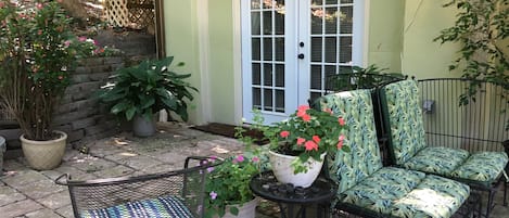 Outside entrance with seating and flowers on patio