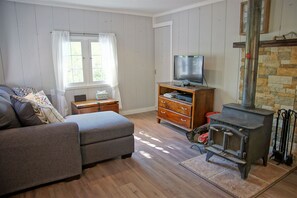 Living Room with HDTV.  
(**The wood stove is currently unusable)