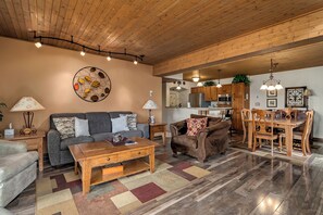 Living room with a view into the dining room and kitchen,