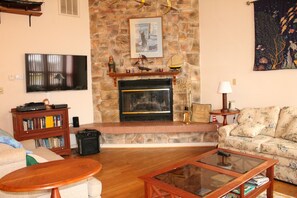 Beautiful open living room with stone fireplace.